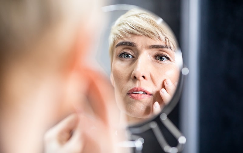 Woman looking in mirror