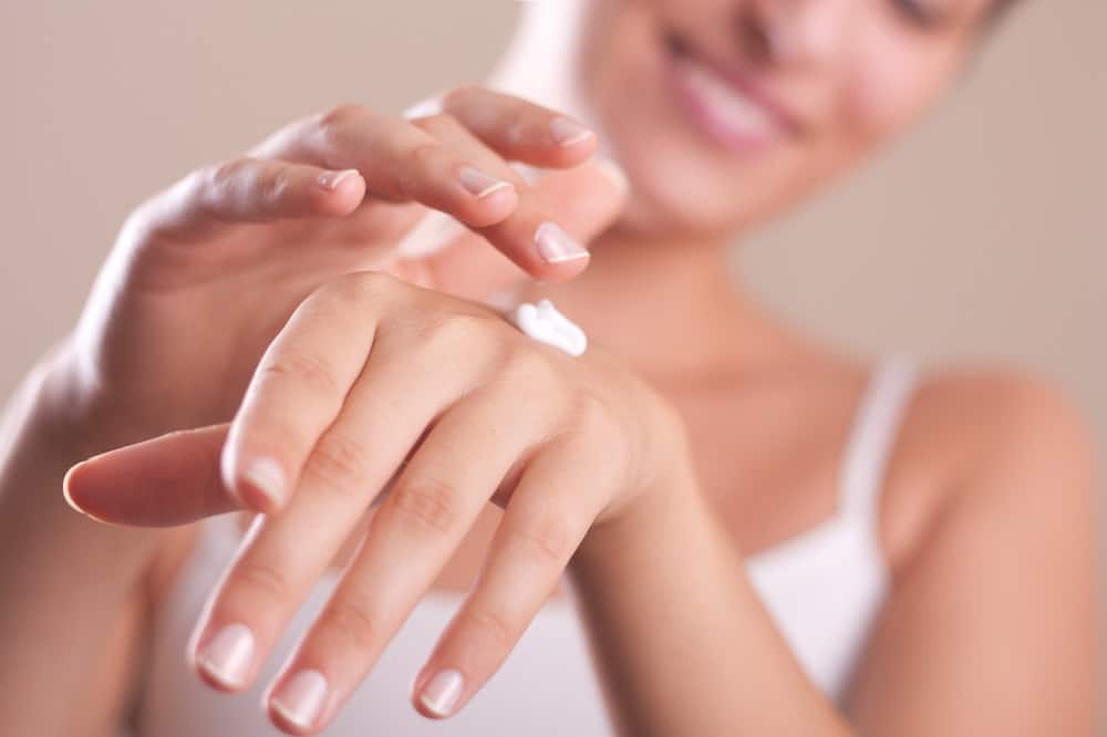 Woman applying hand cream