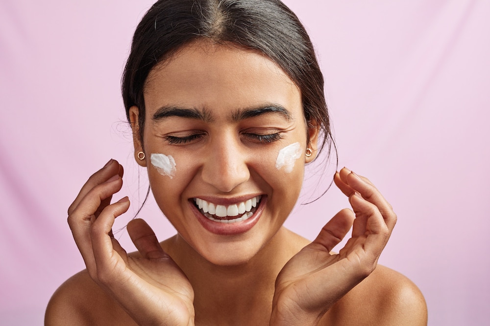 Woman applying skin care products