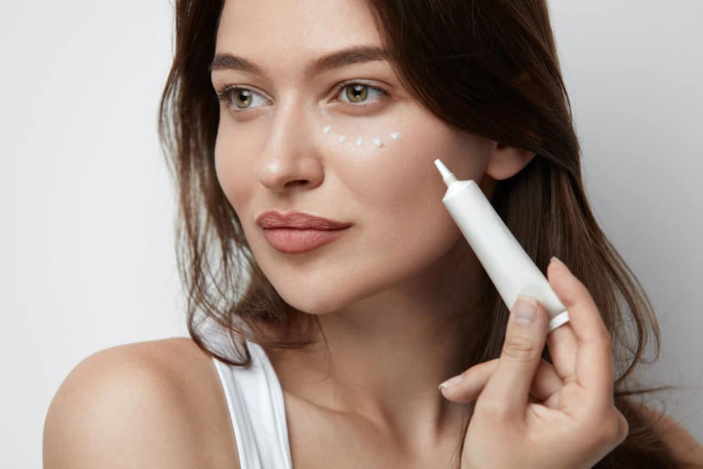 Woman applying eye cream