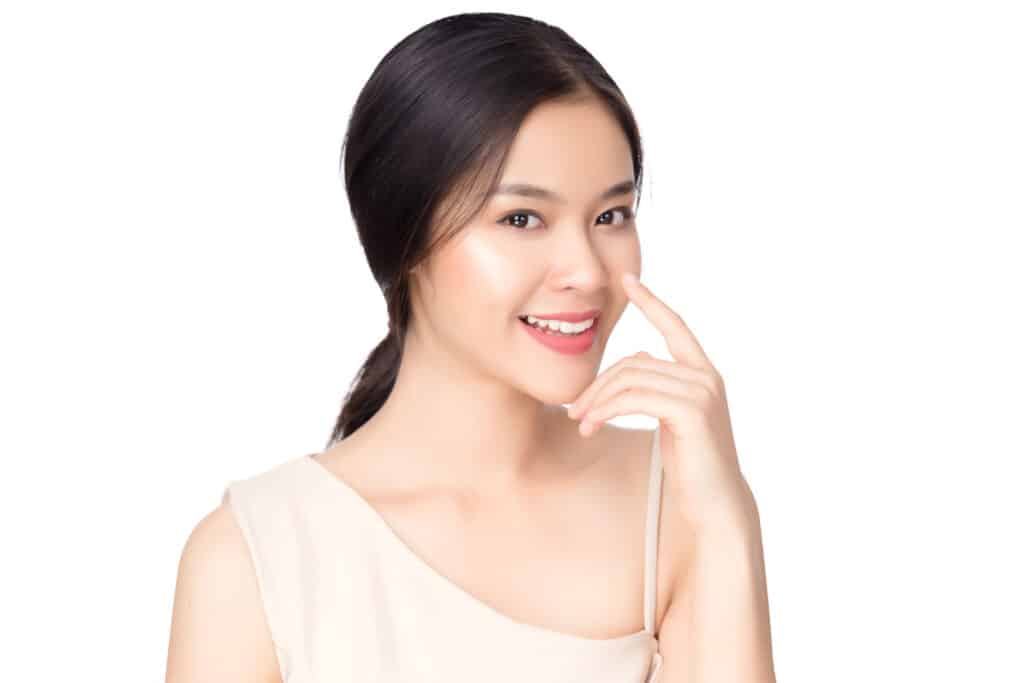A woman smiling and showing the results of JUVÉDERM®