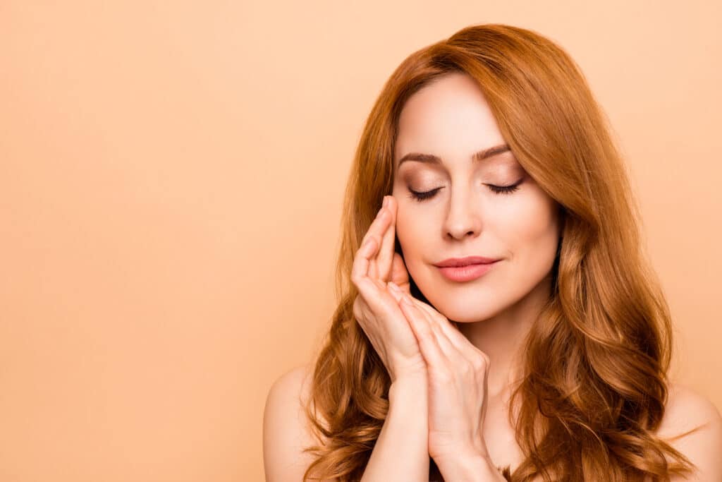 A woman showing off the results of the VI Peel treatment
