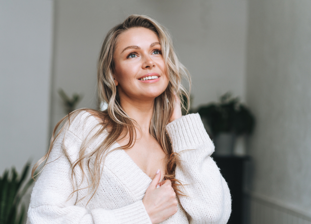 Woman smiling with nice skin and full lips after Versa+ and Lips+ injectable treatment.