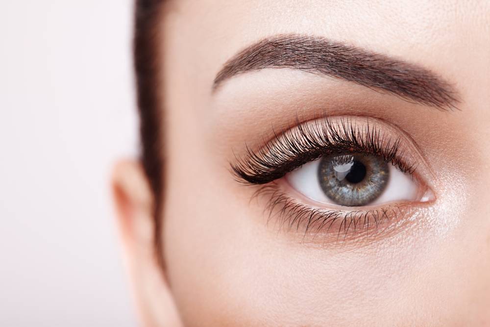 Closeup of woman's eye showing long, full lashes after using Latisse eyelash treatment.